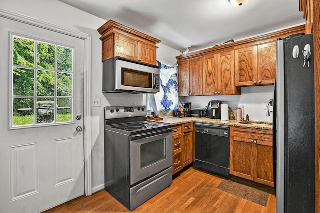 224 E Higgins St, Midway, KY 40347 - kitchen with stainless steel appliances, dark wood-style floors, and brown cabinetry