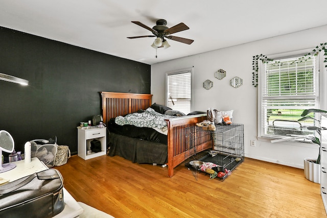 224 E Higgins St, Midway, KY 40347 - bedroom with wood finished floors, multiple windows, and a ceiling fan