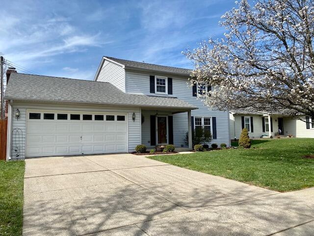 2929 Waco Rd, Lexington, KY 40503 - traditional-style house featuring concrete driveway, a garage, and a front yard