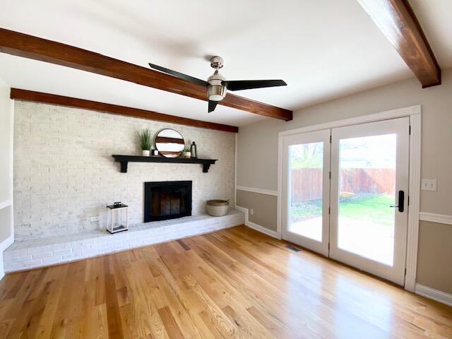 2929 Waco Rd, Lexington, KY 40503 - unfurnished living room featuring beamed ceiling, a fireplace, wood finished floors, and a ceiling fan