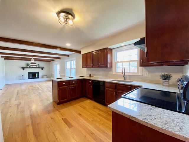 2929 Waco Rd, Lexington, KY 40503 - kitchen with black dishwasher, a peninsula, light wood finished floors, open floor plan, and beamed ceiling