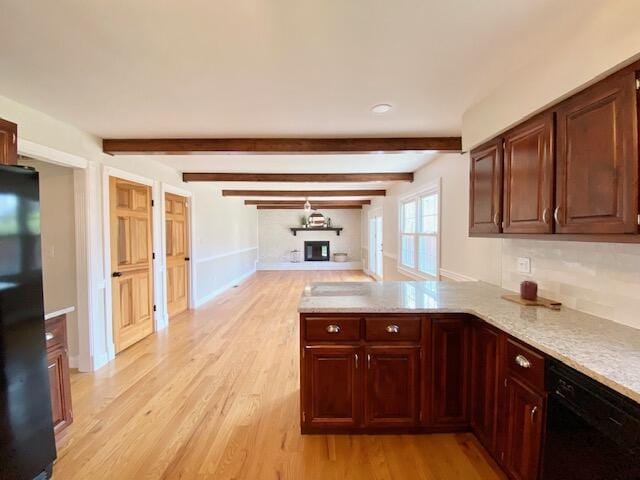 2929 Waco Rd, Lexington, KY 40503 - kitchen with black appliances, a peninsula, light wood-style flooring, beam ceiling, and tasteful backsplash