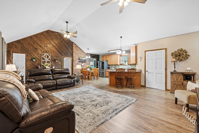 200 Maxwell Ln, Somerset, KY 42503 - living room with ceiling fan, wooden walls, lofted ceiling, and light wood-style flooring