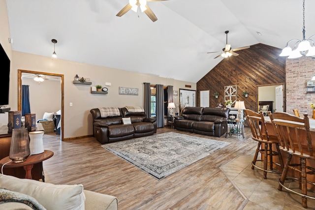 200 Maxwell Ln, Somerset, KY 42503 - living room featuring a ceiling fan, wooden walls, wood finished floors, and high vaulted ceiling