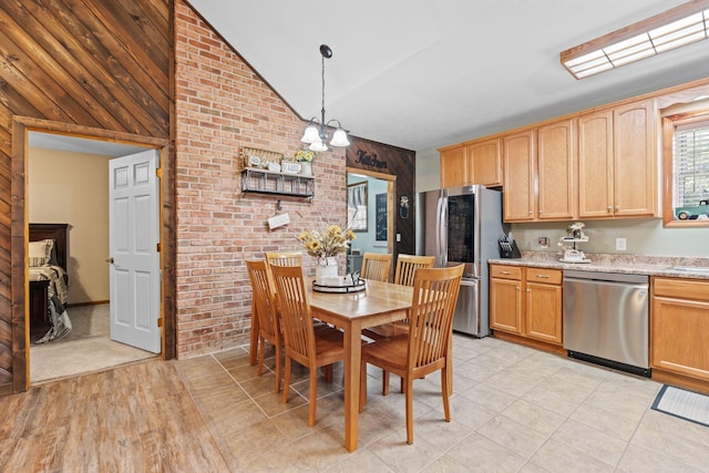 200 Maxwell Ln, Somerset, KY 42503 - dining room featuring vaulted ceiling, wooden walls, a chandelier, and light tile patterned floors