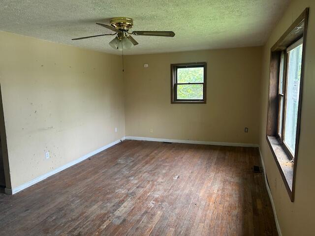 977 Muddy Creek Rd, Winchester, KY 40391 - unfurnished room with dark wood-type flooring, a textured ceiling, and ceiling fan