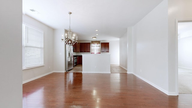 705 Dawson Springs Way, Lexington, KY 40511 - unfurnished living room with a chandelier, light wood finished floors, and healthy amount of natural light