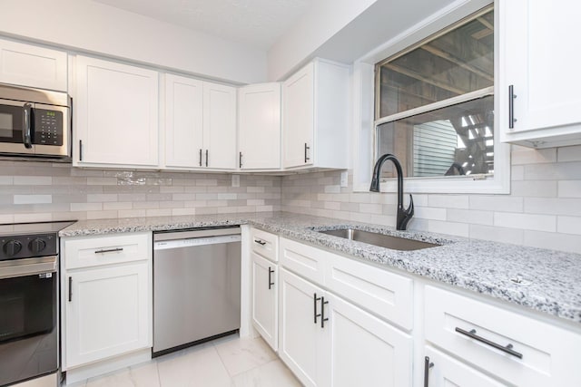 421 Redding Rd Unit 99, Lexington, KY 40517 - kitchen with stainless steel appliances, white cabinetry, tasteful backsplash, and light stone countertops