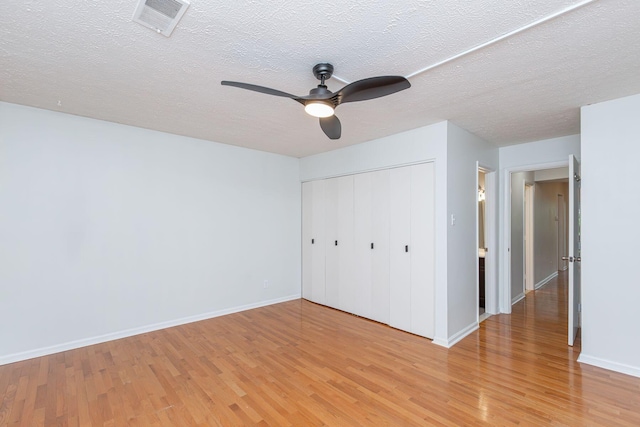 421 Redding Rd Unit 99, Lexington, KY 40517 - unfurnished bedroom featuring light wood-type flooring, a closet, a textured ceiling, and ceiling fan