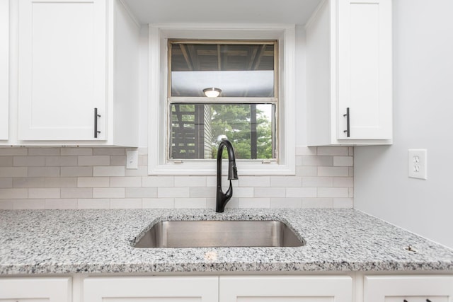 421 Redding Rd Unit 99, Lexington, KY 40517 - kitchen with white cabinetry, tasteful backsplash, and light stone counters