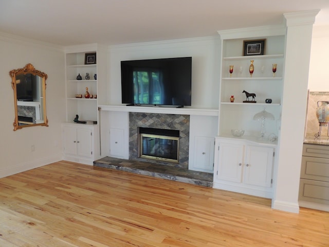 13 Scotland Dr, Frankfort, KY 40601 - unfurnished living room featuring built in features, wood finished floors, ornamental molding, and a tiled fireplace