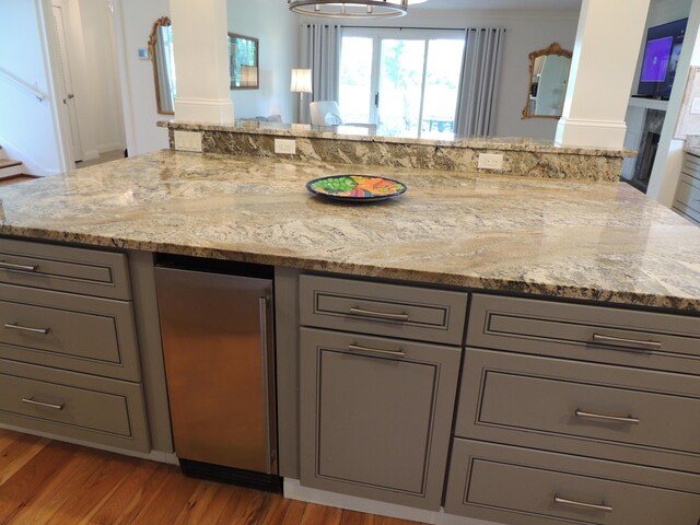 13 Scotland Dr, Frankfort, KY 40601 - kitchen featuring gray cabinetry, light wood finished floors, light stone countertops, ornate columns, and fridge