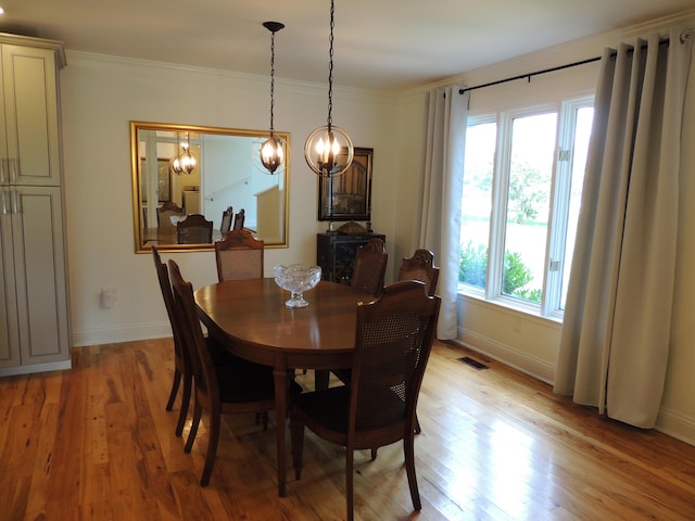13 Scotland Dr, Frankfort, KY 40601 - dining room with healthy amount of natural light, light wood-type flooring, a chandelier, and ornamental molding