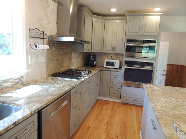 13 Scotland Dr, Frankfort, KY 40601 - kitchen with stainless steel appliances, wall chimney exhaust hood, backsplash, and light wood-type flooring