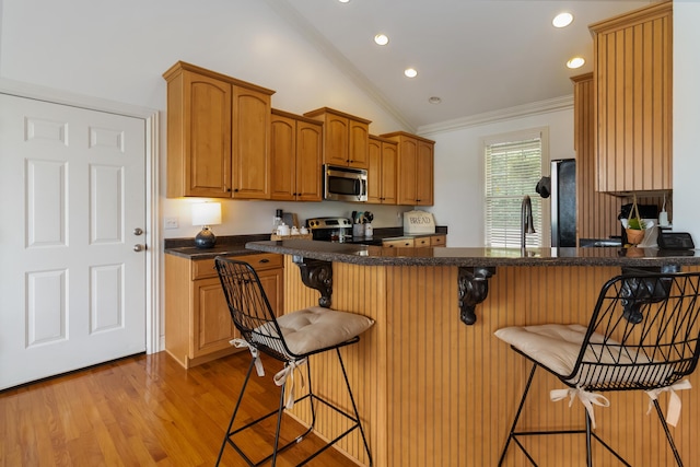 195 Couch Baker Ln, London, KY 40744 - kitchen with stainless steel appliances, ornamental molding, a breakfast bar area, light wood-type flooring, and recessed lighting