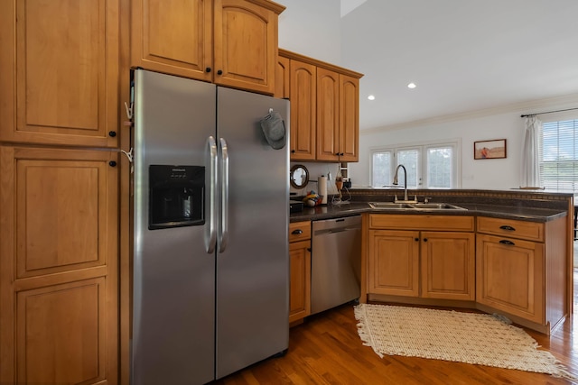 195 Couch Baker Ln, London, KY 40744 - kitchen featuring stainless steel appliances, a peninsula, crown molding, dark wood-style floors, and dark countertops
