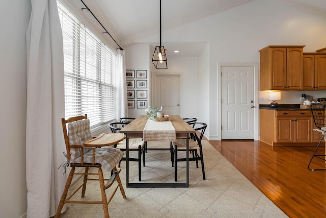 195 Couch Baker Ln, London, KY 40744 - dining space with vaulted ceiling, crown molding, and light wood-style flooring