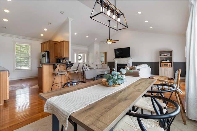 195 Couch Baker Ln, London, KY 40744 - dining space featuring crown molding, lofted ceiling, a fireplace, a ceiling fan, and recessed lighting