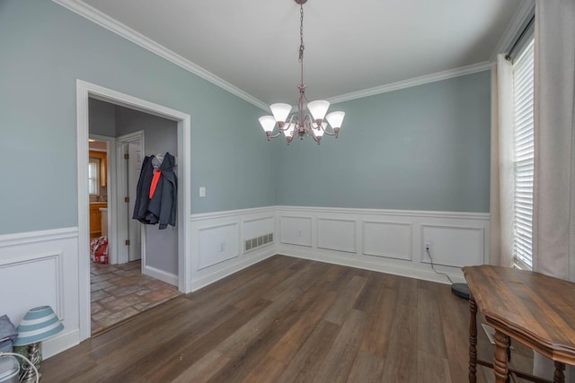 106 Squires Pointe Rd, Paris, KY 40361 - unfurnished dining area featuring a chandelier, crown molding, wainscoting, dark wood-style flooring, and a decorative wall