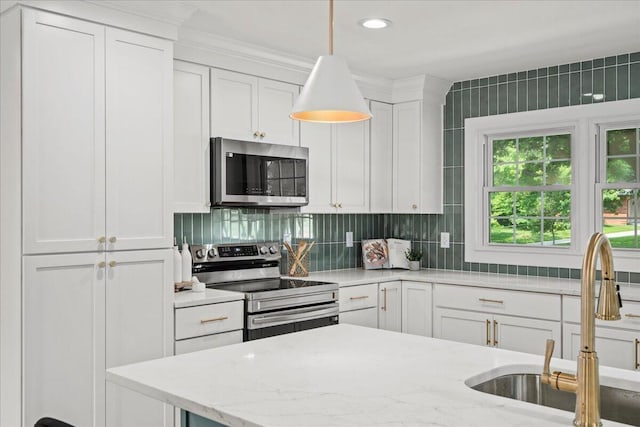 2940 Southview Dr, Lexington, KY 40503 - kitchen with stainless steel appliances, white cabinetry, tasteful backsplash, decorative light fixtures, and light stone countertops