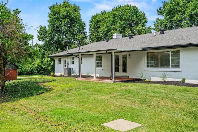 2940 Southview Dr, Lexington, KY 40503 - rear view of house with french doors, a lawn, brick siding, and roof with shingles