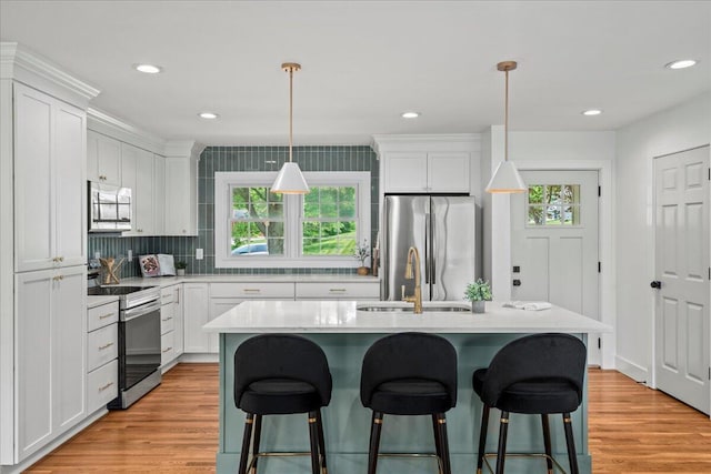 2940 Southview Dr, Lexington, KY 40503 - kitchen with stainless steel appliances, a breakfast bar, light countertops, white cabinetry, and recessed lighting