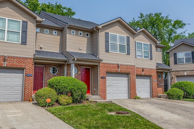 3123 Daly Pl, Lexington, KY 40511 - townhome / multi-family property with driveway, a garage, brick siding, and roof with shingles