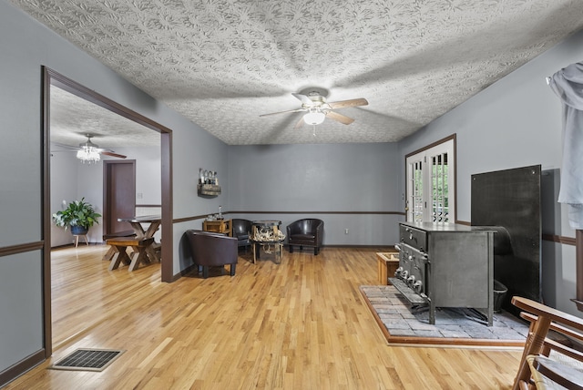 1651 Waits Rd, Cynthiana, KY 41031 - living room with a ceiling fan, light wood-type flooring, and a wood stove