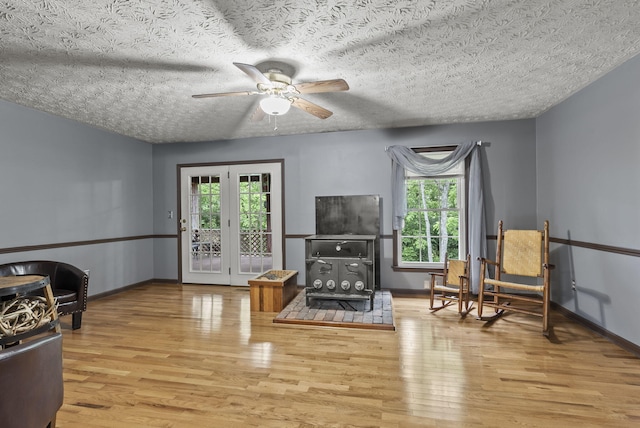 1651 Waits Rd, Cynthiana, KY 41031 - living area featuring wood finished floors, healthy amount of natural light, a ceiling fan, a textured ceiling, and a wood stove