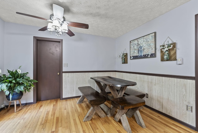 1651 Waits Rd, Cynthiana, KY 41031 - dining area featuring wood-type flooring, a wainscoted wall, ceiling fan, a textured ceiling, and wood walls