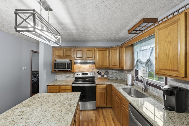 1651 Waits Rd, Cynthiana, KY 41031 - kitchen with appliances with stainless steel finishes, under cabinet range hood, light wood-style floors, a textured ceiling, and brown cabinetry