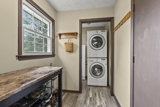 1651 Waits Rd, Cynthiana, KY 41031 - laundry area featuring estacked washer and dryer, light wood finished floors, and a textured ceiling