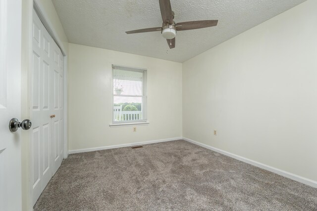 242 Possum Ridge Rd, West Liberty, KY 41472 - unfurnished bedroom with a closet, a textured ceiling, carpet flooring, and ceiling fan