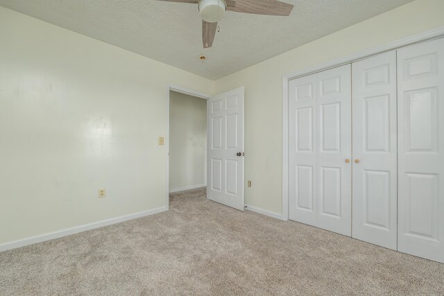 242 Possum Ridge Rd, West Liberty, KY 41472 - unfurnished bedroom featuring carpet, a closet, a textured ceiling, and ceiling fan
