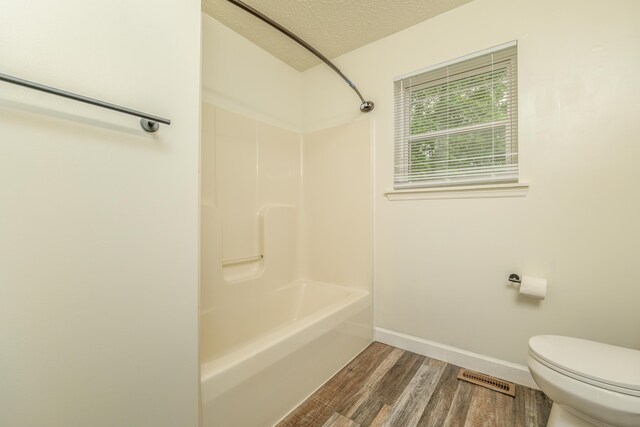 242 Possum Ridge Rd, West Liberty, KY 41472 - bathroom with wood finished floors, tub / shower combination, and a textured ceiling