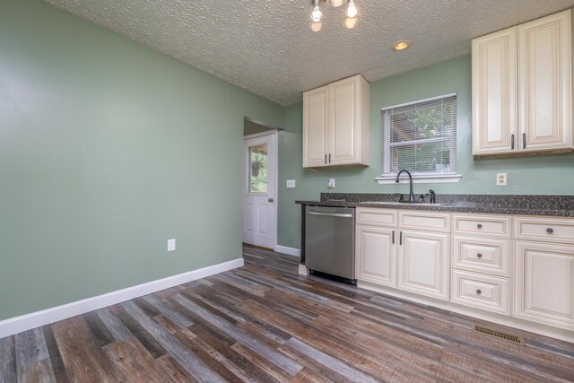 242 Possum Ridge Rd, West Liberty, KY 41472 - kitchen featuring stainless steel dishwasher, dark wood-style floors, healthy amount of natural light, a textured ceiling, and white cabinetry