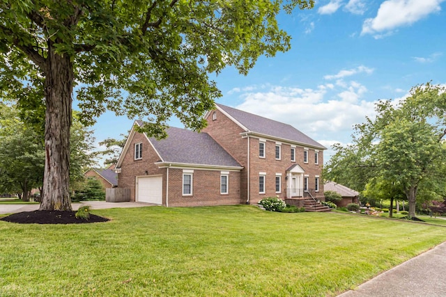 4991 Tynebrae Rd, Lexington, KY 40515 - colonial-style house featuring brick siding, a garage, a front yard, concrete driveway, and roof with shingles