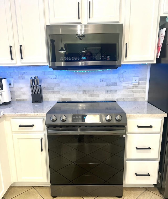 2368 Lonan Ct, Lexington, KY 40511 - kitchen with stainless steel appliances, light tile patterned flooring, light stone counters, and white cabinets