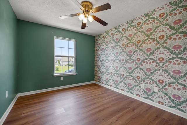 720 Pinoak Dr, Nicholasville, KY 40356 - unfurnished room featuring wallpapered walls, a textured ceiling, wood finished floors, and ceiling fan
