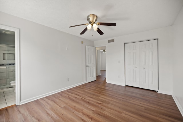 720 Pinoak Dr, Nicholasville, KY 40356 - unfurnished bedroom with wood finished floors, connected bathroom, a closet, and a ceiling fan
