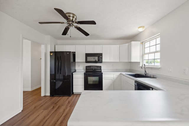 720 Pinoak Dr, Nicholasville, KY 40356 - kitchen with black appliances, light wood-style flooring, light countertops, white cabinetry, and a textured ceiling