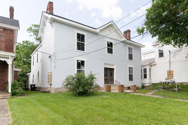 411 High St, Paris, KY 40361 - back of house with a chimney, brick siding, a lawn, and entry steps