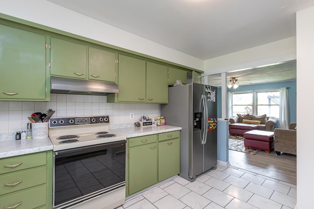 111 Hagan Ct, Lancaster, KY 40444 - kitchen with electric stove, under cabinet range hood, light countertops, stainless steel fridge, and decorative backsplash