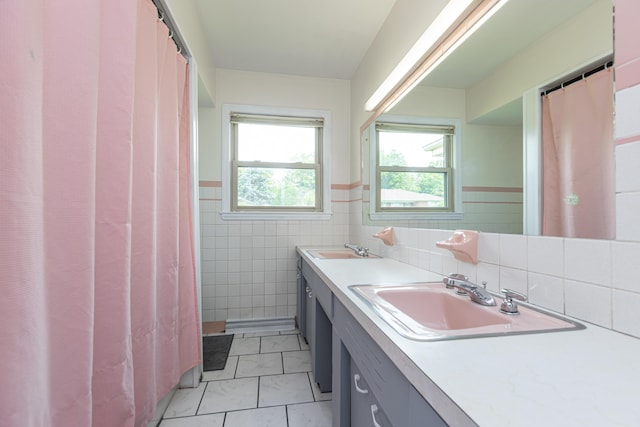 111 Hagan Ct, Lancaster, KY 40444 - full bathroom with marble finish floors, tile walls, double vanity, and a wainscoted wall