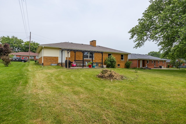 111 Hagan Ct, Lancaster, KY 40444 - rear view of property featuring brick siding, a chimney, a yard, and a patio area