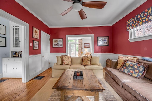 315 Desha Rd, Lexington, KY 40502 - living room featuring hardwood / wood-style floors, a ceiling fan, a wainscoted wall, and crown molding