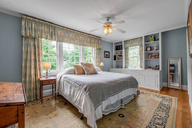 315 Desha Rd, Lexington, KY 40502 - bedroom featuring multiple windows, ornamental molding, light wood-style floors, and a ceiling fan