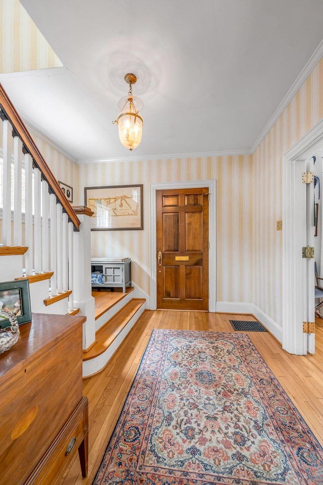 315 Desha Rd, Lexington, KY 40502 - entrance foyer featuring hardwood / wood-style flooring, wallpapered walls, stairs, a chandelier, and ornamental molding