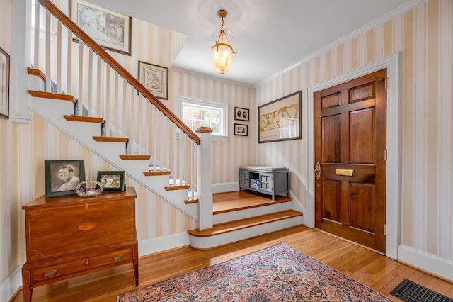 315 Desha Rd, Lexington, KY 40502 - foyer entrance with hardwood / wood-style floors, wallpapered walls, stairs, and crown molding
