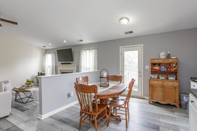 4026 Briar Creek Dr, Lawrenceburg, KY 40342 - dining space with ceiling fan, light wood-style flooring, a tile fireplace, and recessed lighting